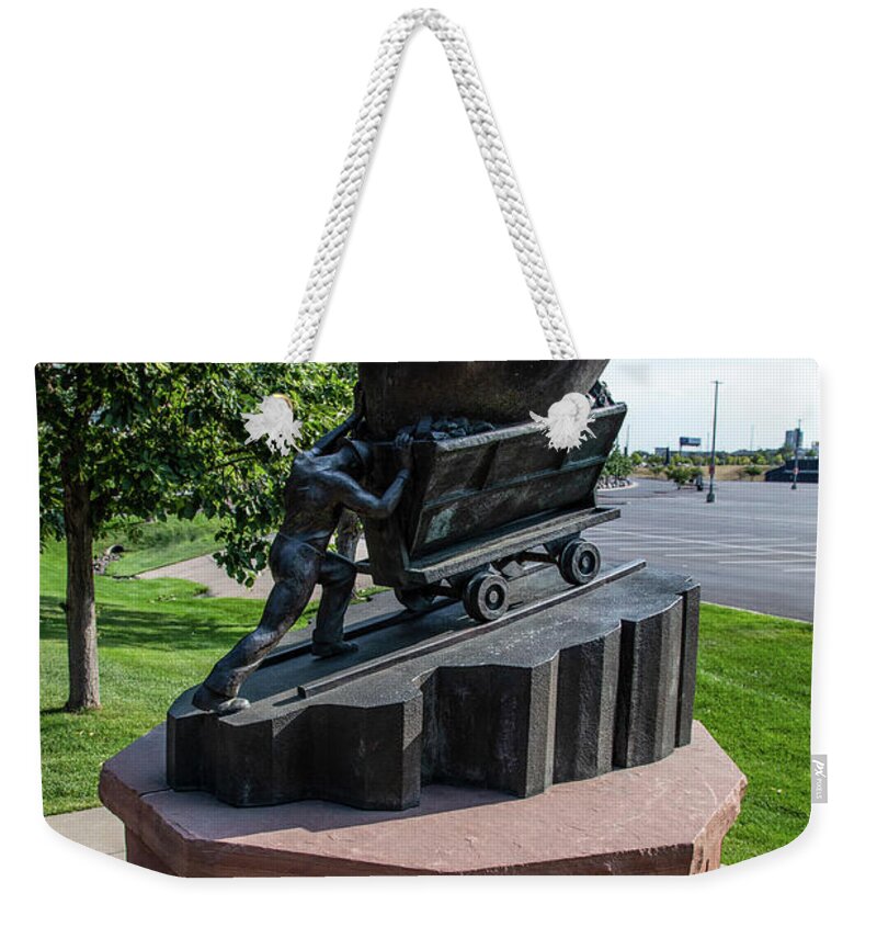 Denver Colorado Weekender Tote Bag featuring the photograph Mining and football statue outside Empower Field at Mile High Stadium in Denver Colorado by Eldon McGraw