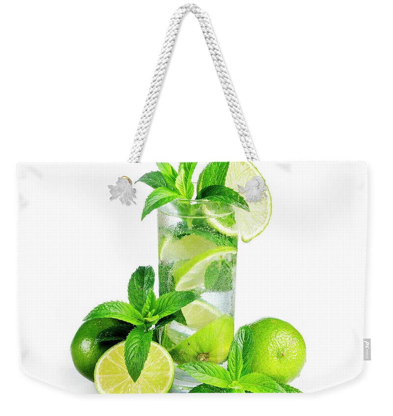 Mojito Weekender Tote Bag featuring the photograph Mojito cocktail with ice isolated over white background. by Jelena Jovanovic