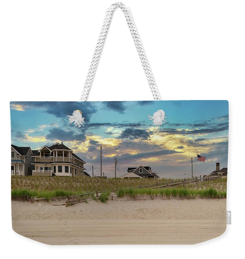 Beach Weekender Tote Bag featuring the photograph Moody Skies Behind the Beach Houses by Matthew DeGrushe