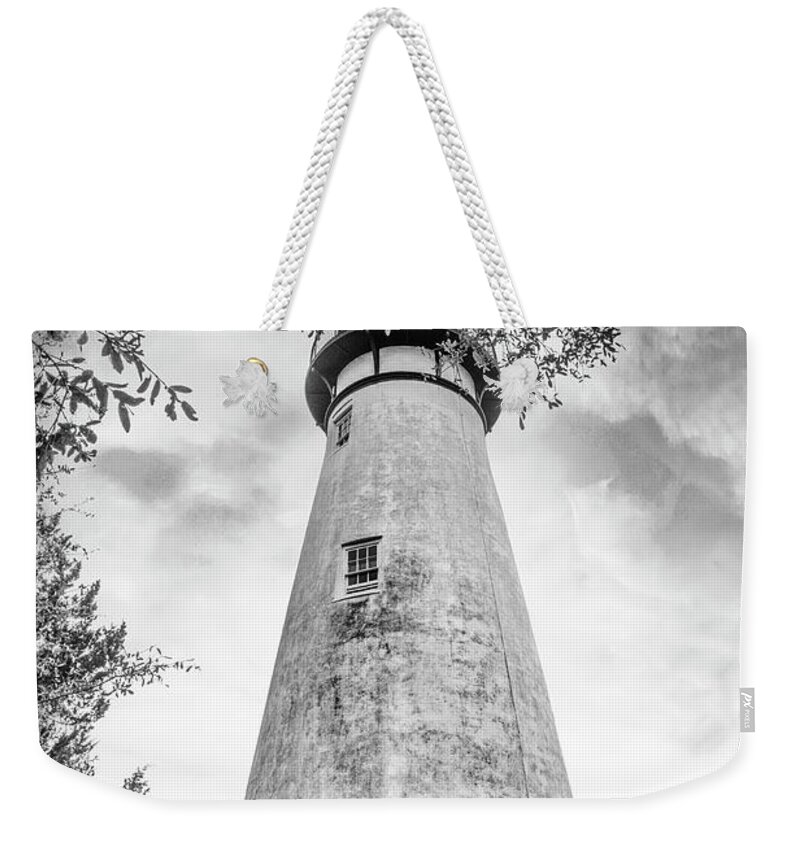 Black Weekender Tote Bag featuring the photograph Mossy Trees around the Amelia Island Lighthouse Black and White by Debra and Dave Vanderlaan