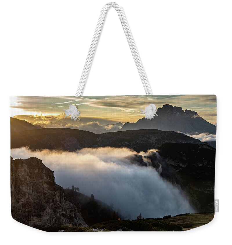 Tre Cime Weekender Tote Bag featuring the photograph Mountain landscape with fog, at the Tre Cime hiking path area i by Michalakis Ppalis