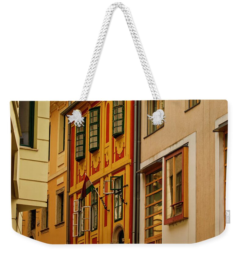 Old Weekender Tote Bag featuring the photograph Narrow street with colorful old town houses by Mendelex Photography