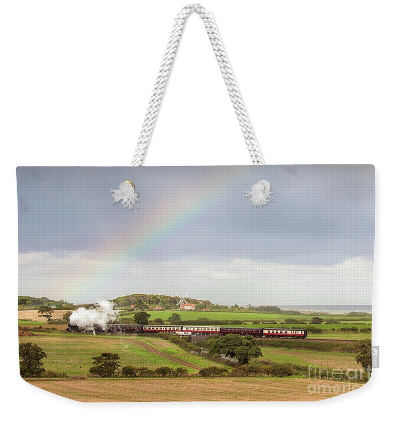 Weybourne Weekender Tote Bag featuring the photograph Norfolk steam train with Weybourne windmill and rainbow by Simon Bratt