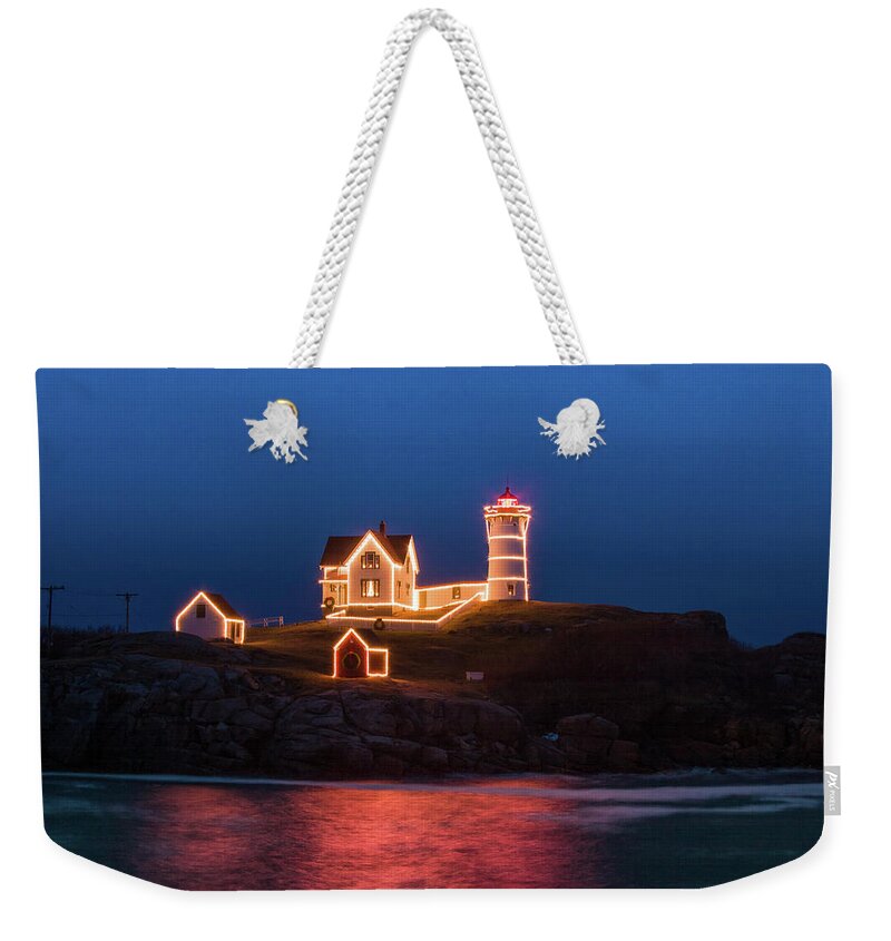 Maine Lighthouse Weekender Tote Bag featuring the photograph Nubble lighthouse with Christmas Lights by Jeff Folger