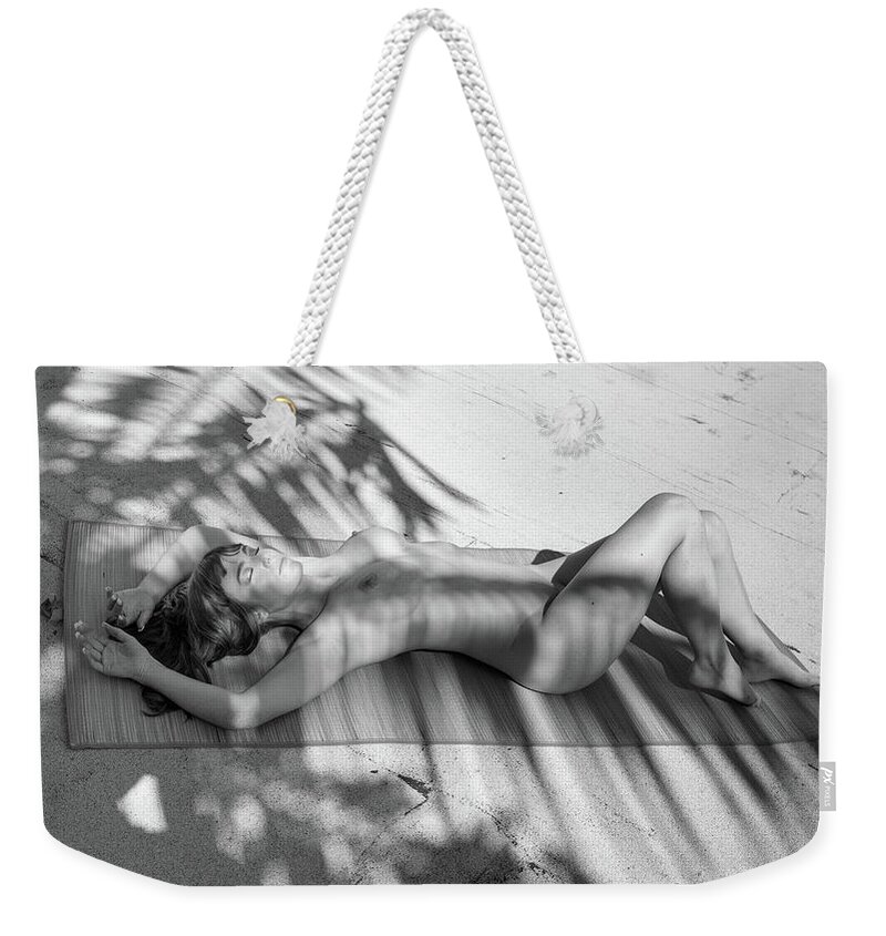 Nude Weekender Tote Bag featuring the photograph Nude sunbathing under the palms by Michael Fryd