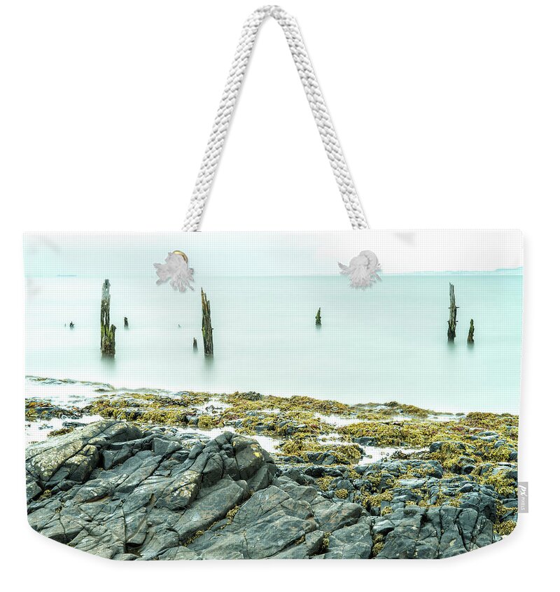 Holy Island Weekender Tote Bag featuring the photograph Old Posts and the Rocks - wide angle view by John Paul Cullen