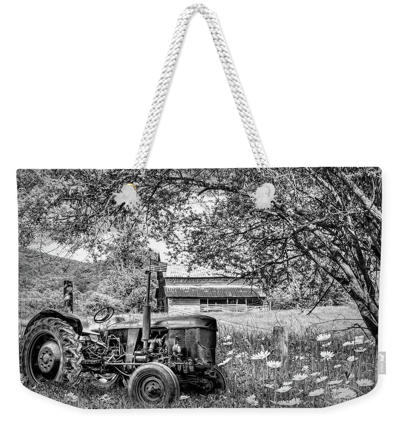 Black Weekender Tote Bag featuring the photograph Old Tractor in the Wildflowers Black and White by Debra and Dave Vanderlaan