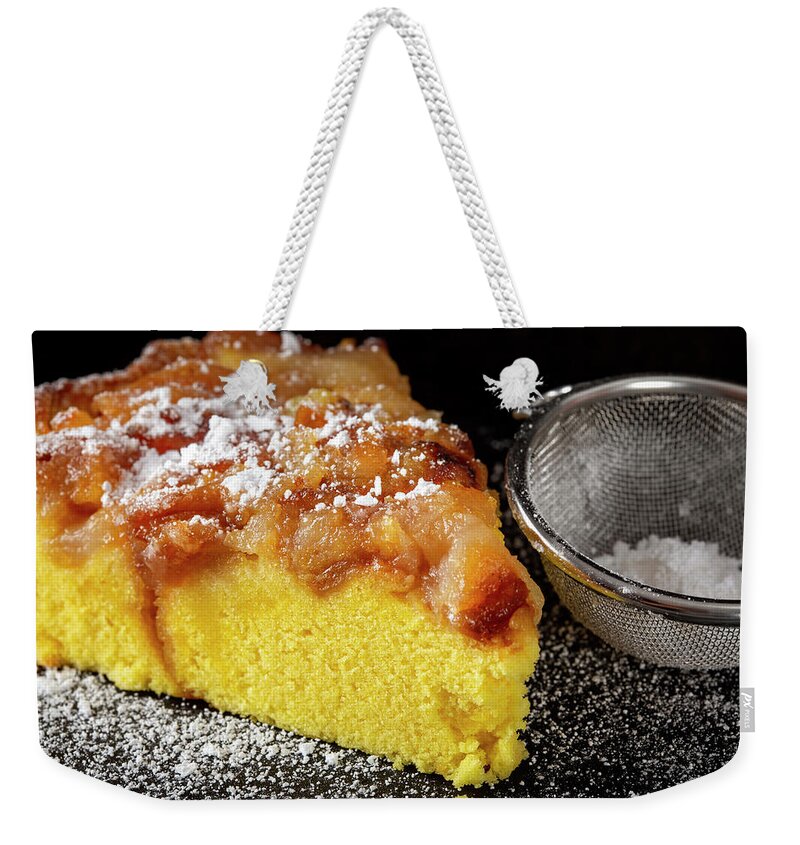 Cake Weekender Tote Bag featuring the photograph One slice of an apple cake with powder sugar by Sebastian Radu