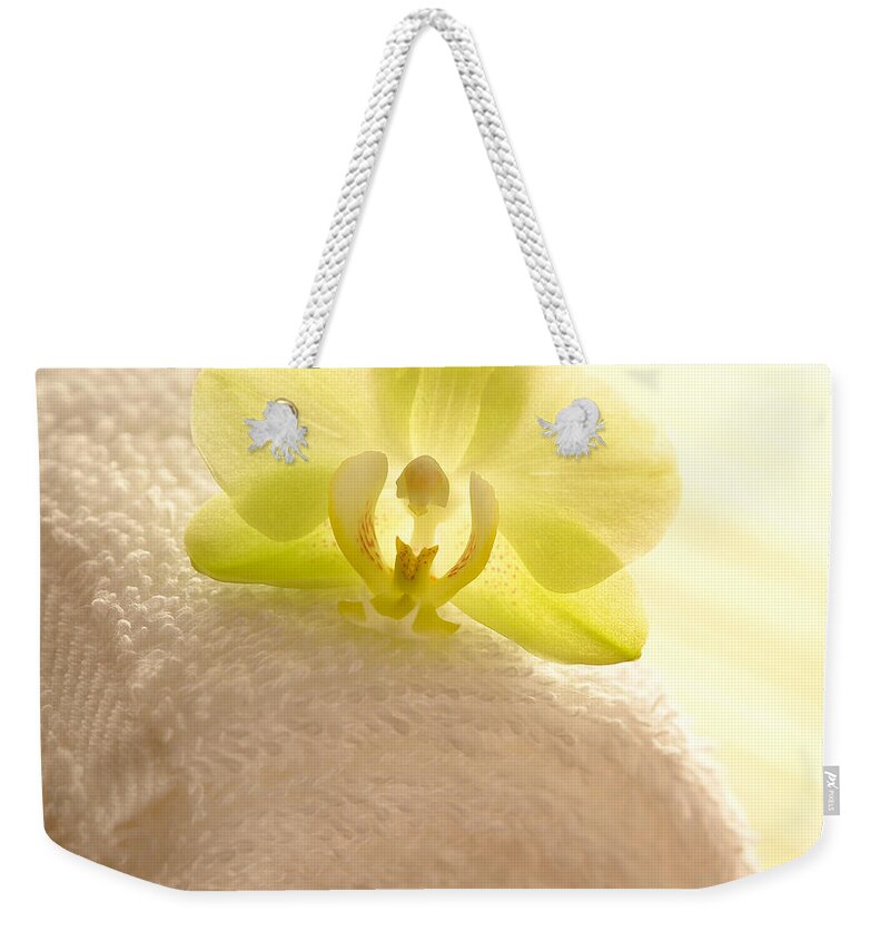Orchid Weekender Tote Bag featuring the photograph Orchid on Towel by Olivier Le Queinec