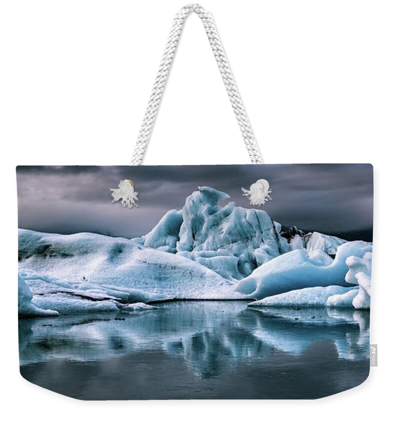 Lagoon Weekender Tote Bag featuring the photograph Panorama of icebergs in the Jokulsarlon glacial lagoon, Vatnajokull National Park, Southern Iceland. Stormy sky and mirror reflection by Jane Rix