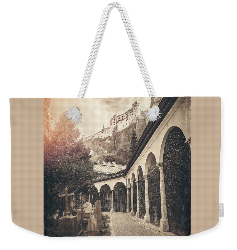 Salzburg Weekender Tote Bag featuring the photograph Petersfriedhof and Salzburg Castle Vintage Sepia by Carol Japp