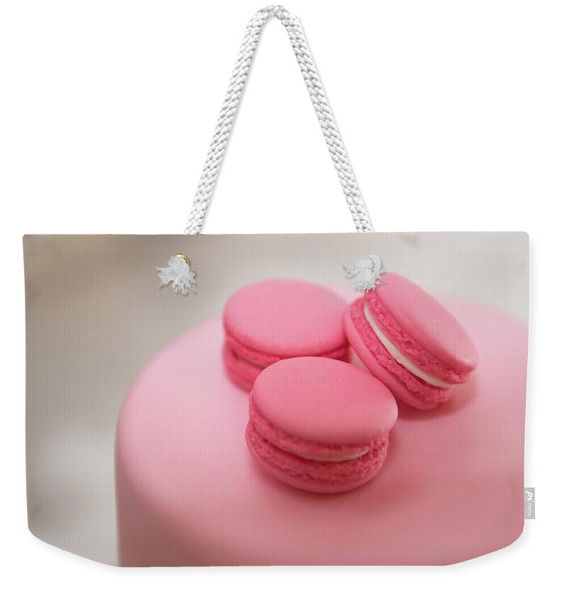 Macaroon Weekender Tote Bag featuring the photograph Pink color french delicious macaroons cookies. Shallow dof by Michalakis Ppalis