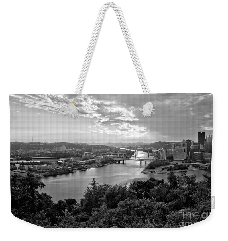 Pittsburgh Weekender Tote Bag featuring the photograph Pittsburgh Fiery Skies Over The Allegheny River Black And White by Adam Jewell