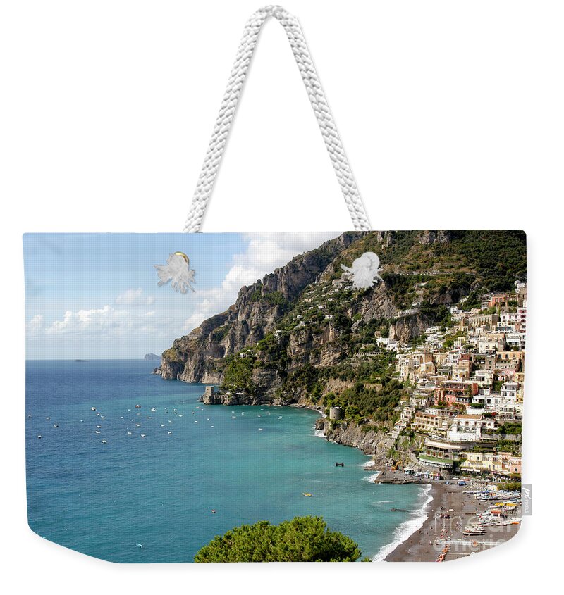  Positano Weekender Tote Bag featuring the photograph Positano on the Amalfi coastline with crystal blue ocean views by Gunther Allen