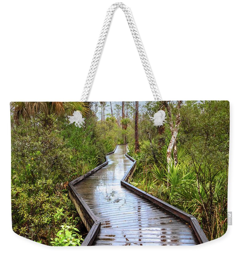 Clouds Weekender Tote Bag featuring the photograph Rainy Reflections on the Boardwalk Trail by Debra and Dave Vanderlaan