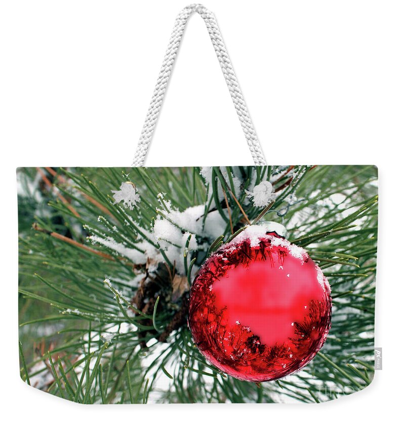 Red Weekender Tote Bag featuring the photograph Red Ornament in Evergreen with Snow by Pete Klinger