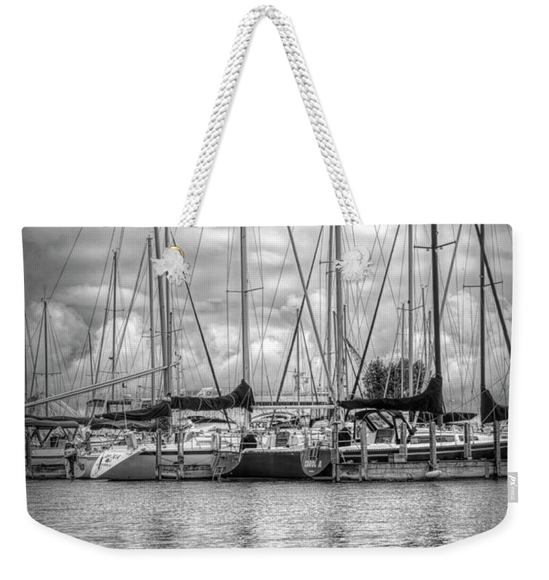 Boats Weekender Tote Bag featuring the photograph Reflections and Boats at the Harbor in Black and White by Debra and Dave Vanderlaan