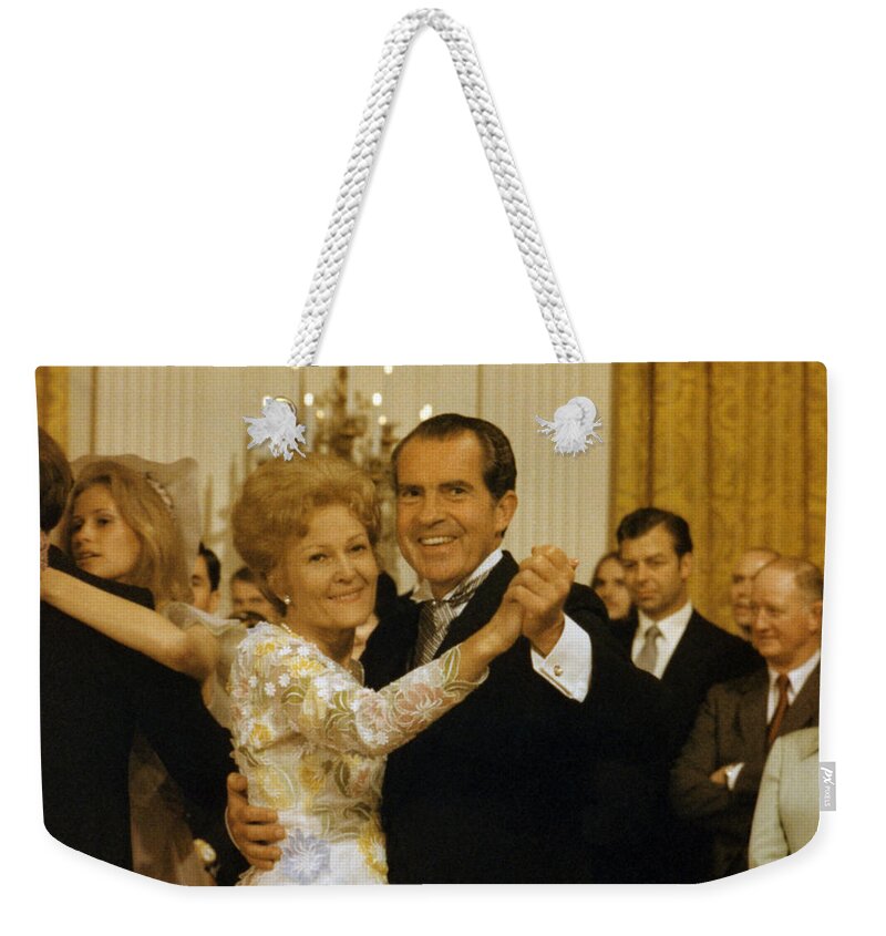 President Nixon Weekender Tote Bag featuring the photograph Richard and Pat Nixon Dancing At The White House - 1971 by War Is Hell Store