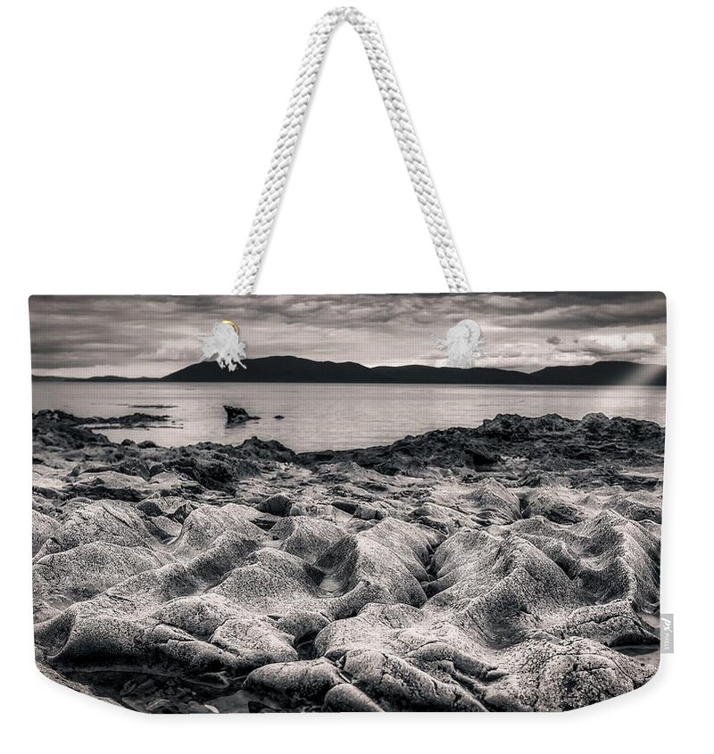 Monochrome Weekender Tote Bag featuring the photograph Rocky dune beach by Bradley Morris