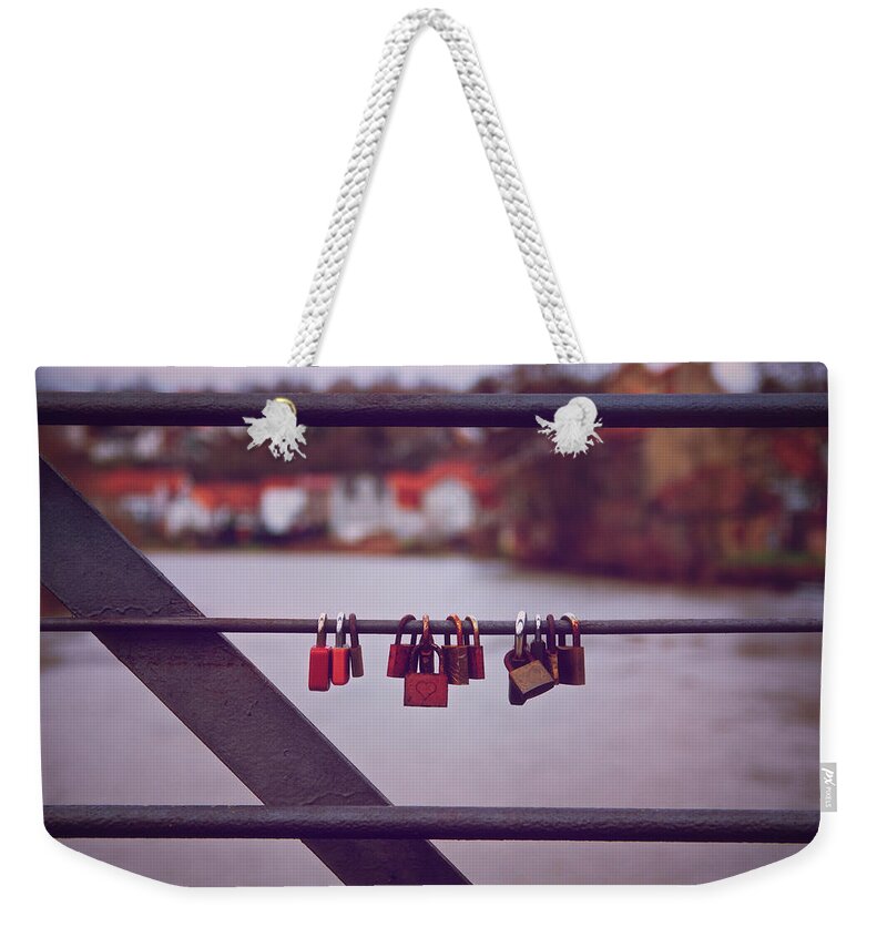 Love Weekender Tote Bag featuring the photograph Romantic lover padlocks on a bridge railing by Mendelex Photography