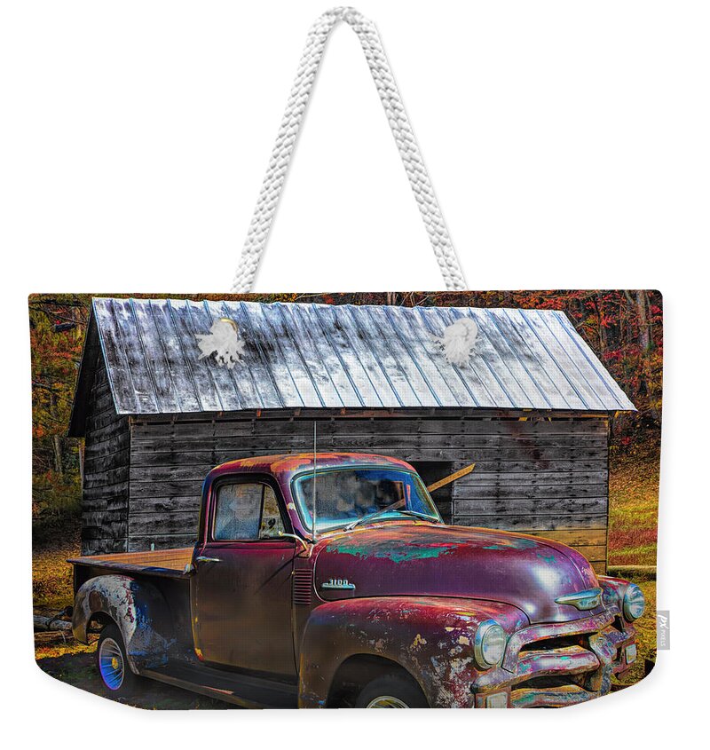 Old Weekender Tote Bag featuring the photograph Rusty Chevy at the Autumn Farm Barn by Debra and Dave Vanderlaan