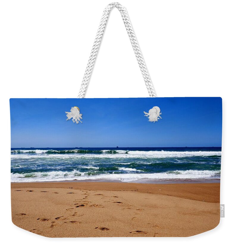 Holiday Weekender Tote Bag featuring the photograph Sand Sea and Blue Sky by Jeremy Hayden