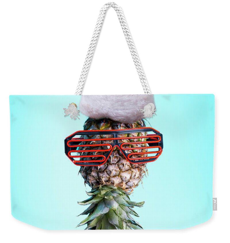 Pineapple Weekender Tote Bag featuring the photograph Santa ananas. Funky pop art minimal christmas in summer concept. by Jelena Jovanovic
