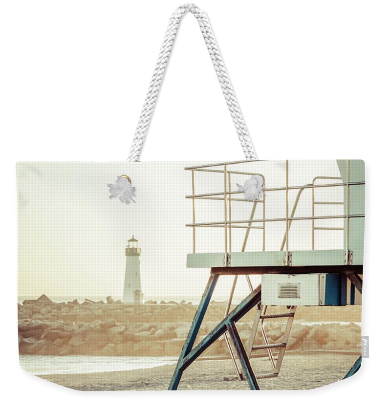 America Weekender Tote Bag featuring the photograph Santa Cruz Beach Lifeguard Station and Lighthouse Photo by Paul Velgos