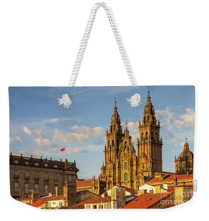 Way Weekender Tote Bag featuring the photograph Santiago de Compostela Cathedral Towers Close Up with Sun Light Hitting the facade and Tiled Roofs La Corua Galicia by Pablo Avanzini