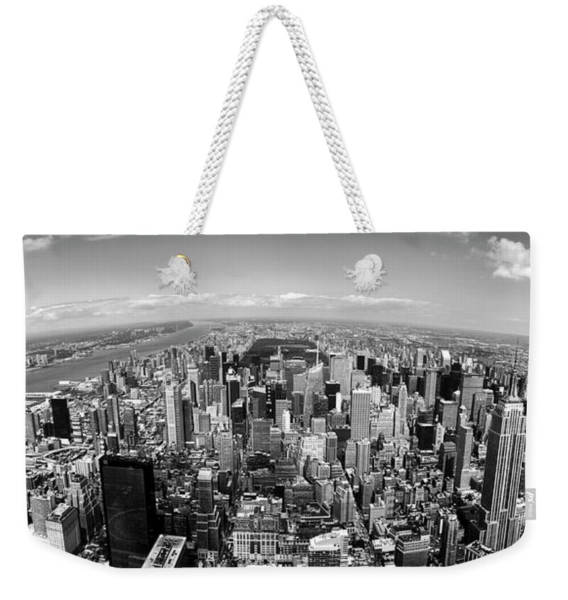 Aerial View Architecture Building Exterior City Cloud Day Fish-eye Lens Horizontal Island Manhattan New York City New York State No People Outdoors Sea Sky Skyline Skyscraper Tall Tower Travel Destinations Urban Scene Usa Black And White Weekender Tote Bag featuring the photograph Skyscrapers in a city, Manhattan, New York City, New York State, USA by Panoramic Images