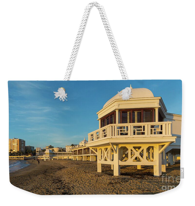 Seascape Weekender Tote Bag featuring the photograph Spa at La Caleta under a Blue Sky Beach in Cadiz Andalusia by Pablo Avanzini