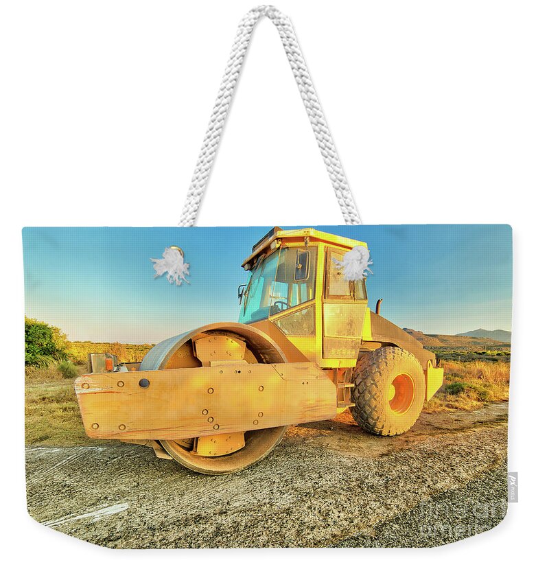 Steamroller Weekender Tote Bag featuring the photograph Steamroller industrial machine by Benny Marty
