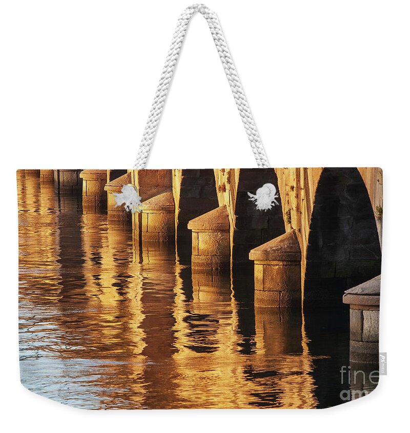 Rocks Weekender Tote Bag featuring the photograph Stone Medieval Viaduct Reflected at Sunset Golden Light Pondedeume Galicia by Pablo Avanzini