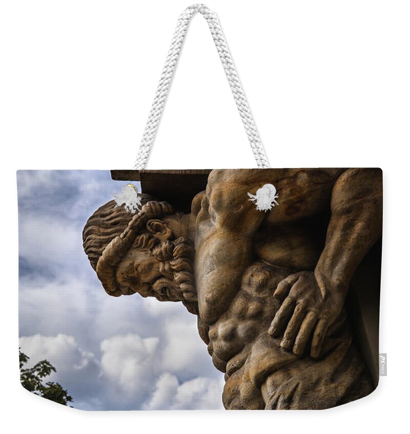 Atlant Weekender Tote Bag featuring the photograph Stone Sculpture Of The Atlas by Artur Bogacki