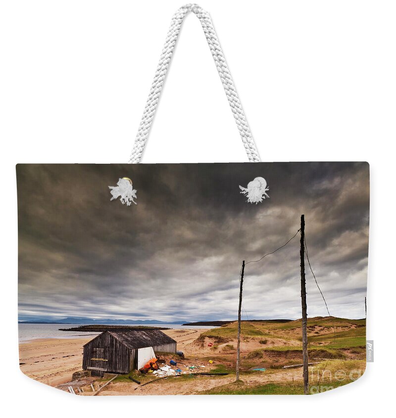 Scotland Beach Weekender Tote Bag featuring the photograph Stormy sky and abandoned fishing hut, Red point beach, Wester Ross, Scotland by Neale And Judith Clark