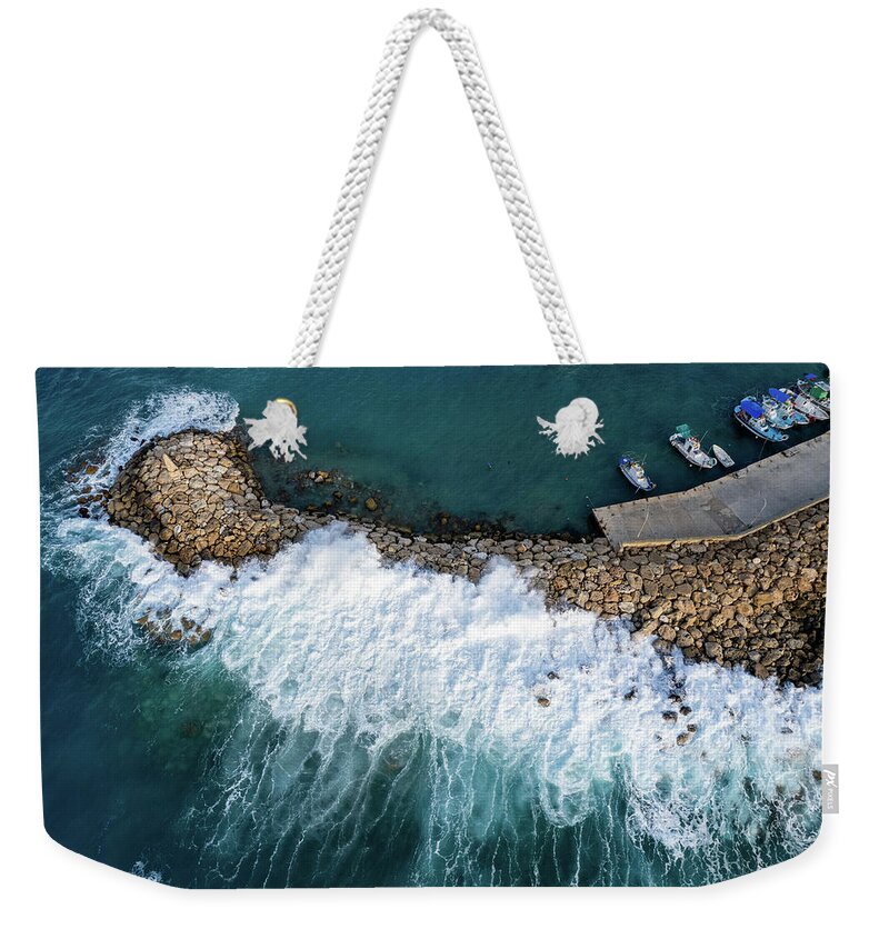 Brakewater Weekender Tote Bag featuring the photograph Stormy windy waves on the shore. Drone photography. by Michalakis Ppalis