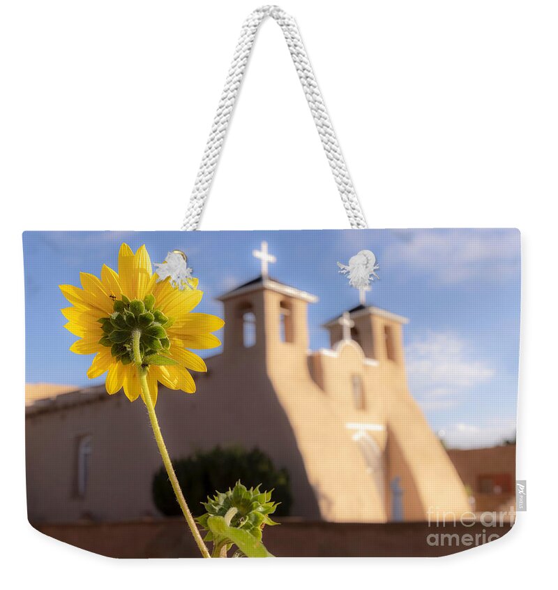 Taos Weekender Tote Bag featuring the photograph Sunflower and the St Francis de Asis Church by Elijah Rael