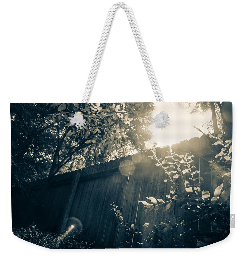 Sunshine Weekender Tote Bag featuring the photograph Sunlight Over the Dark Fence by W Craig Photography