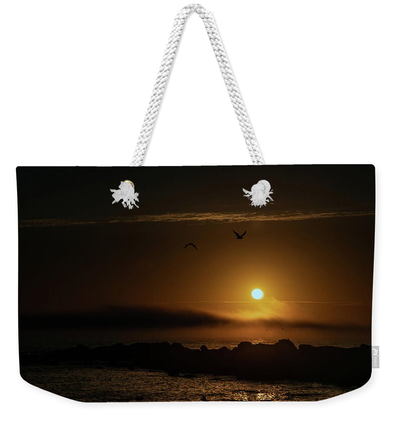 Sunset Weekender Tote Bag featuring the photograph Sunset over the ocean by Micah Offman