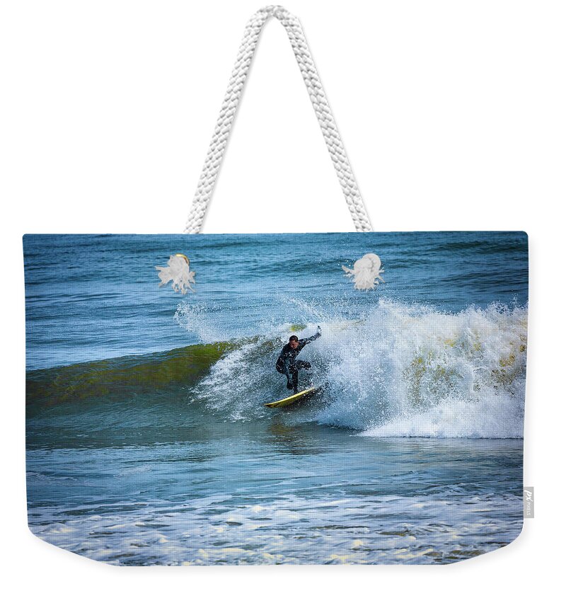 North Carolina Weekender Tote Bag featuring the photograph Surfing the Outer Banks by Dan Carmichael