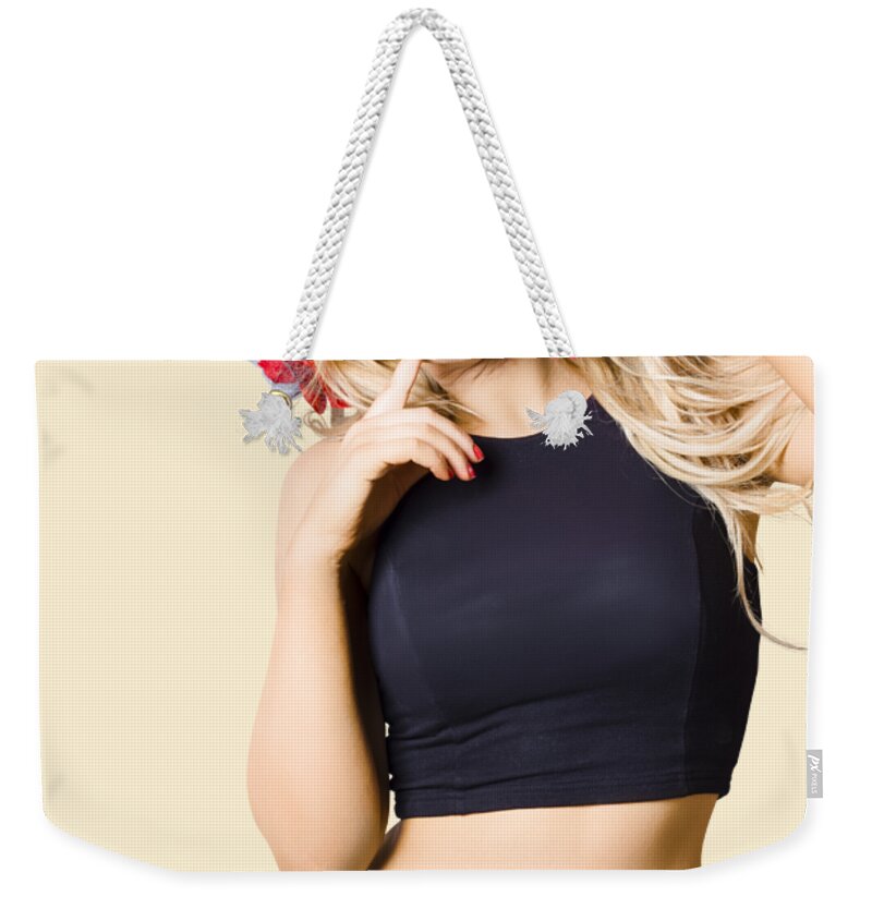 Girl Weekender Tote Bag featuring the photograph Surprised pinup woman isolated on studio backgrond by Jorgo Photography