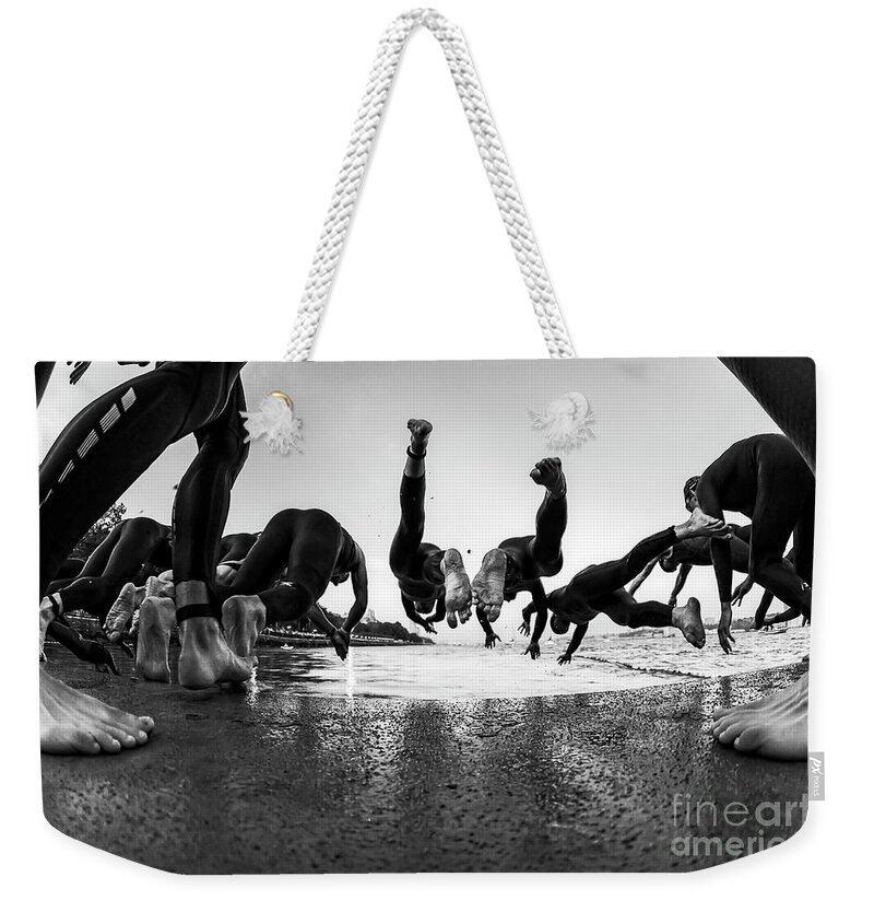 Triathlon Weekender Tote Bag featuring the photograph Swimmers start the NYC Triathlon. by Rich Cruse