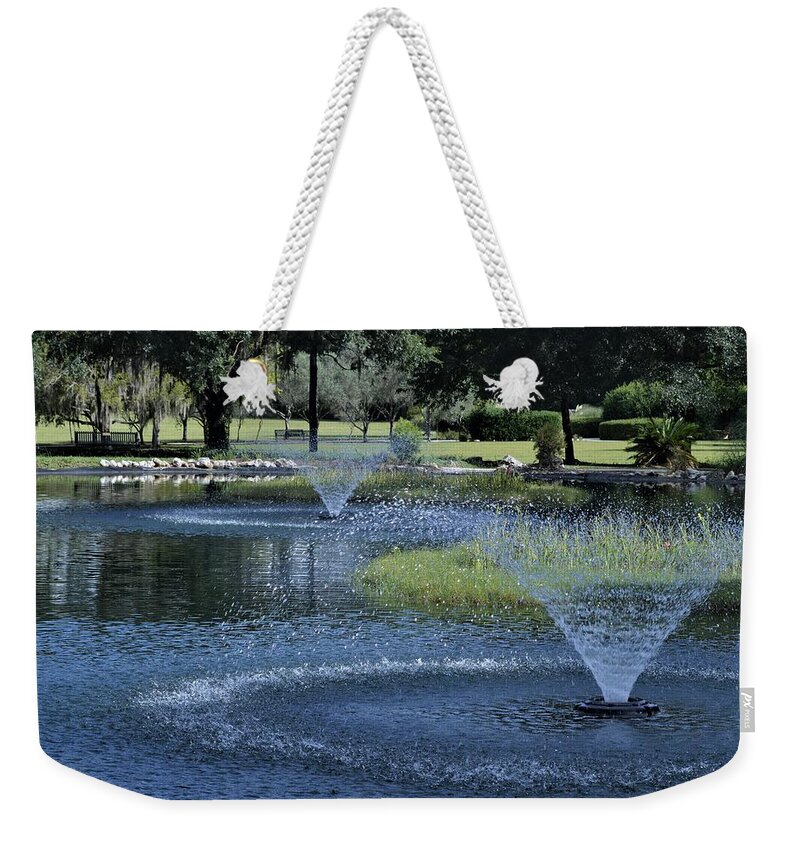 The Fountains At Sholom Park Weekender Tote Bag featuring the photograph The Fountains at Sholom Park by Warren Thompson
