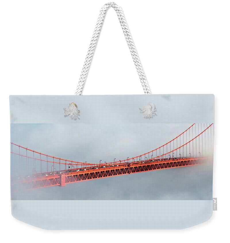 Golden Gate Bridge Weekender Tote Bag featuring the photograph The Iconic Golden Gate Bridge in Fog by Ali Nasser