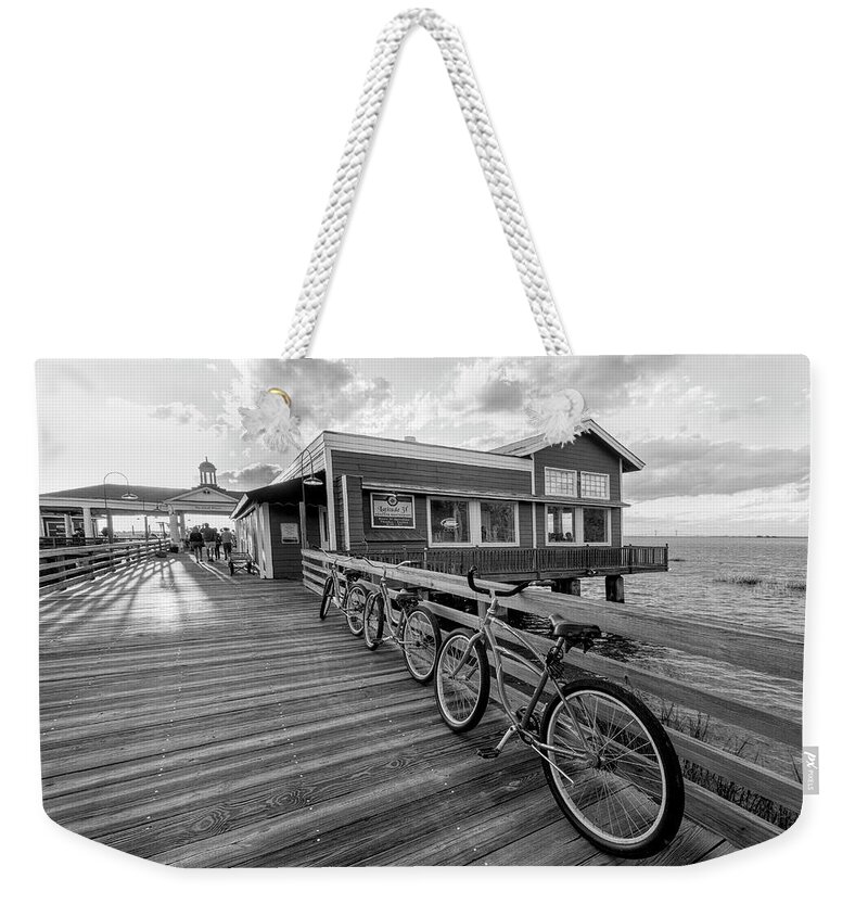 Black Weekender Tote Bag featuring the photograph Three Bicycles on the Dock Black and White Jekyll Island by Debra and Dave Vanderlaan
