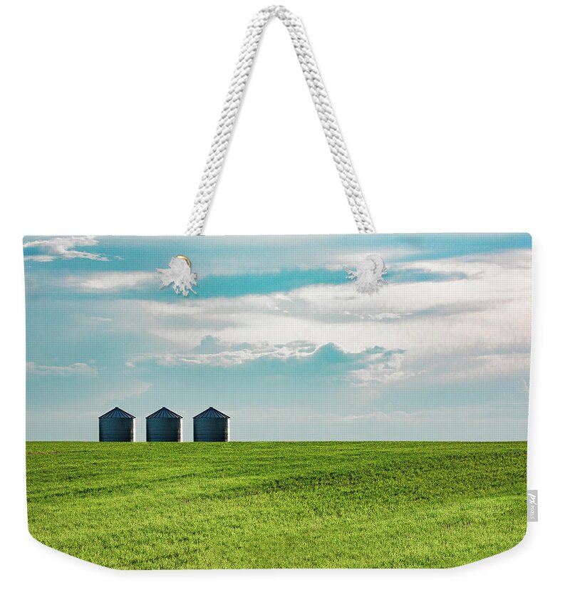 Field Weekender Tote Bag featuring the photograph Three Grain Bins by Todd Klassy