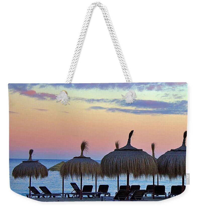 Andalusia Weekender Tote Bag featuring the photograph Tiki Umbrellas and Sunsets by Yvonne M Smith