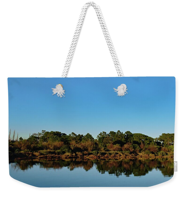 Lake Weekender Tote Bag featuring the photograph Tranquil lake reflections by Angelo DeVal