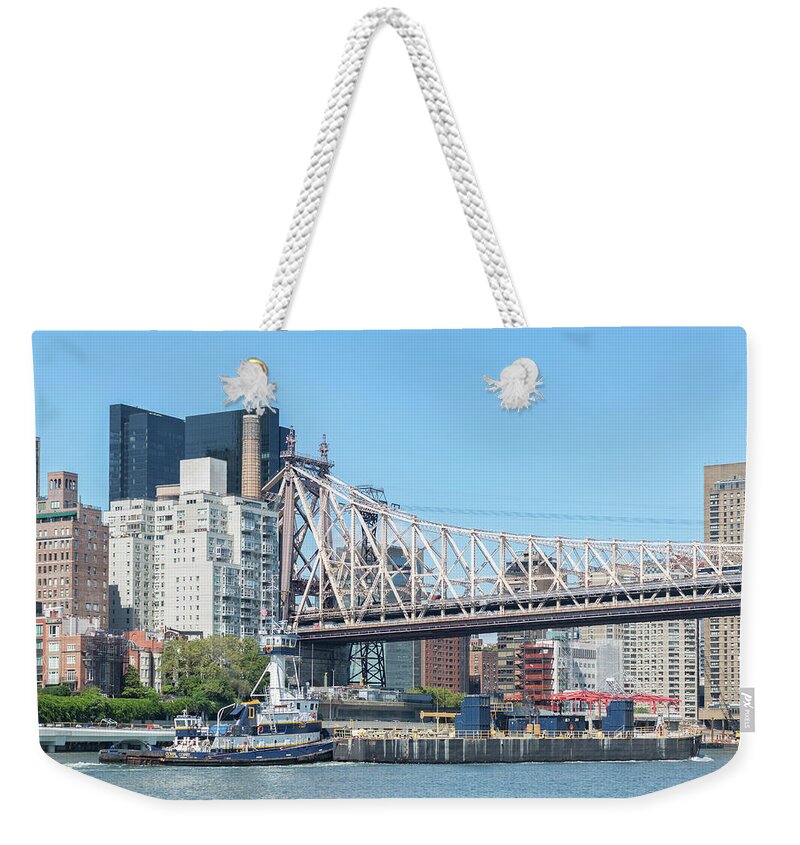 East River Weekender Tote Bag featuring the photograph Tug and Barge Under Bridge by Cate Franklyn