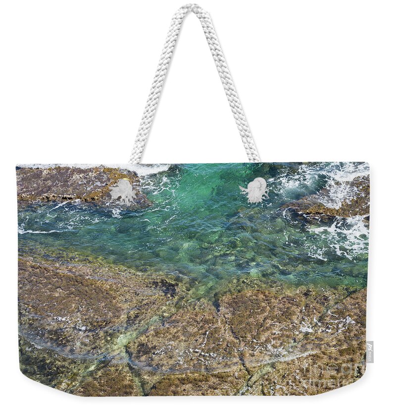 Turquoise Weekender Tote Bag featuring the photograph Turquoise Blue Water And Rocks On The Coast by Adriana Mueller